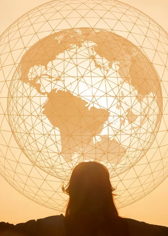 Globe illustration in front of a sunset